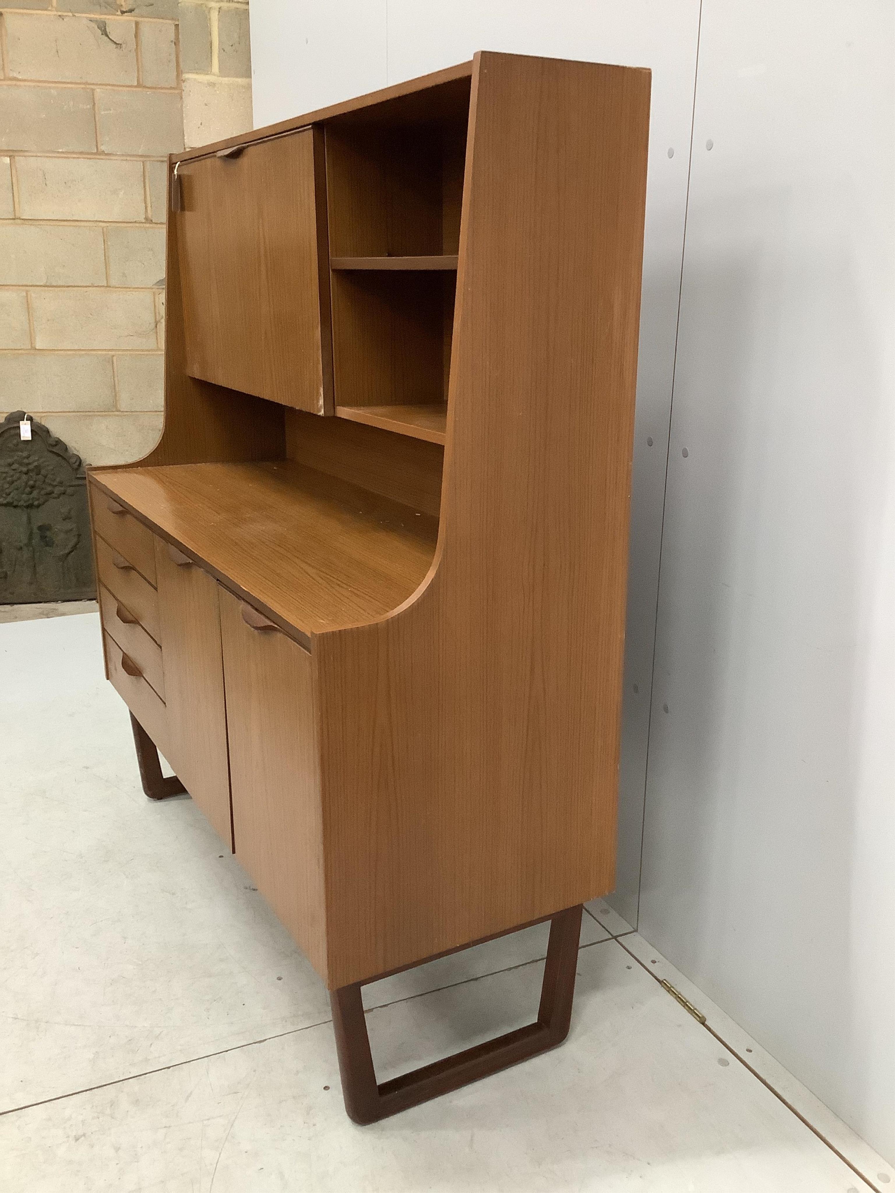 A mid century 'Europa Furniture' simulated teak sideboard, width 125cm, depth 46cm, height 138cm. Condition - fair